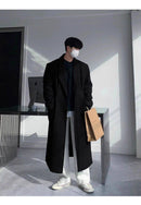 Look completo com Sobretudo Coreano Masculino Longo preto, calça branca e tênis, combinando conforto e sofisticação. Tendência em moda masculina.