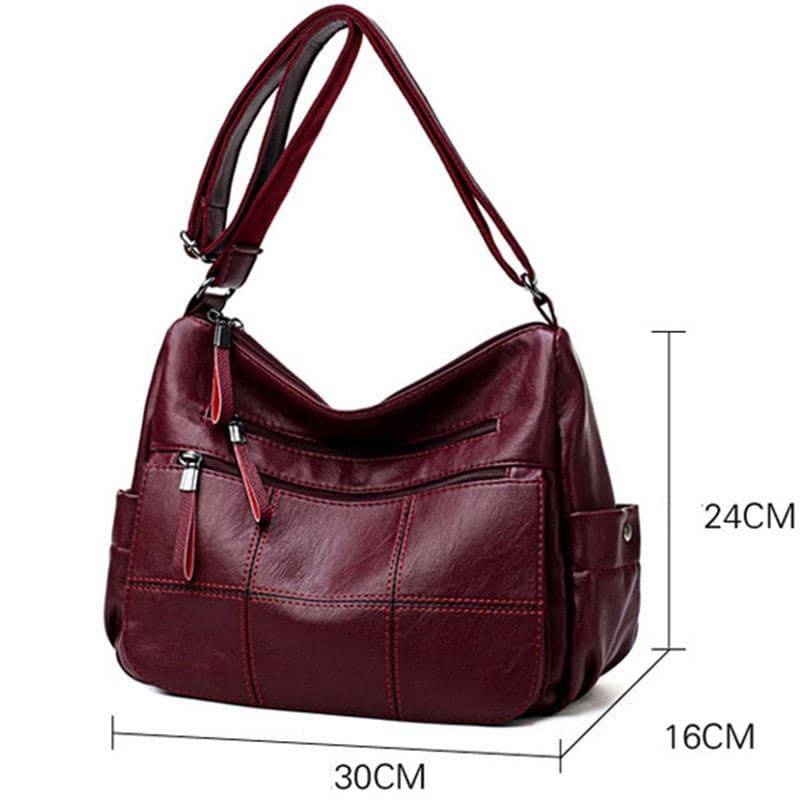 Alt text: Bolsa feminina de couro marrom da marca Loox elegante.