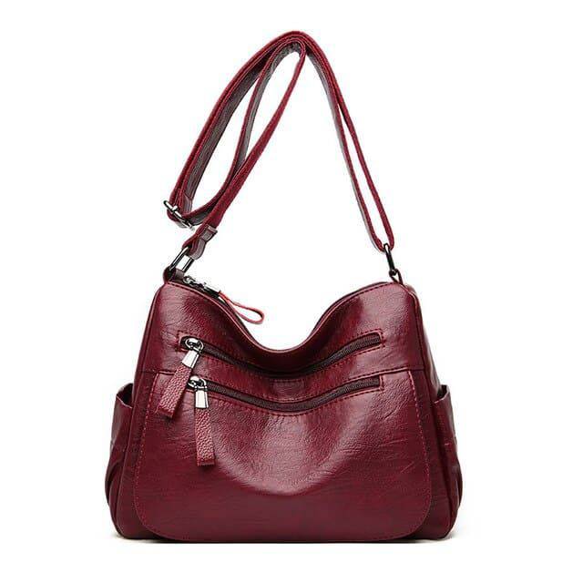 Alt text: Bolsa feminina de couro marrom da marca Loox elegante.