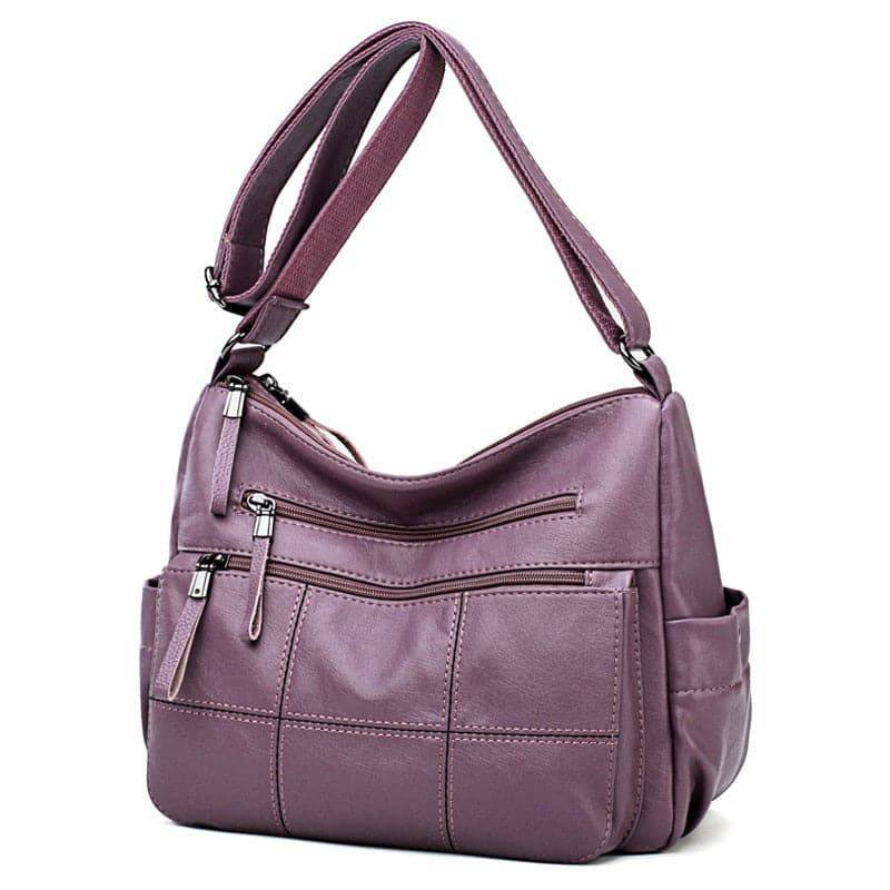 Alt text: Bolsa feminina de couro marrom da marca Loox elegante.