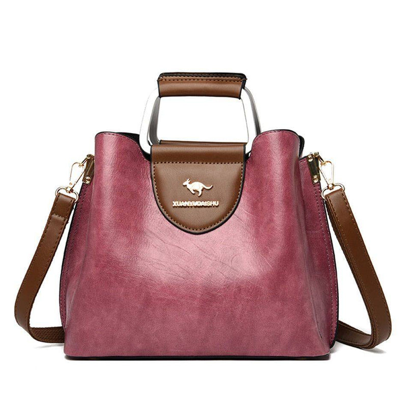 Alt text: Bolsa feminina de couro violeta elegante e sofisticada.