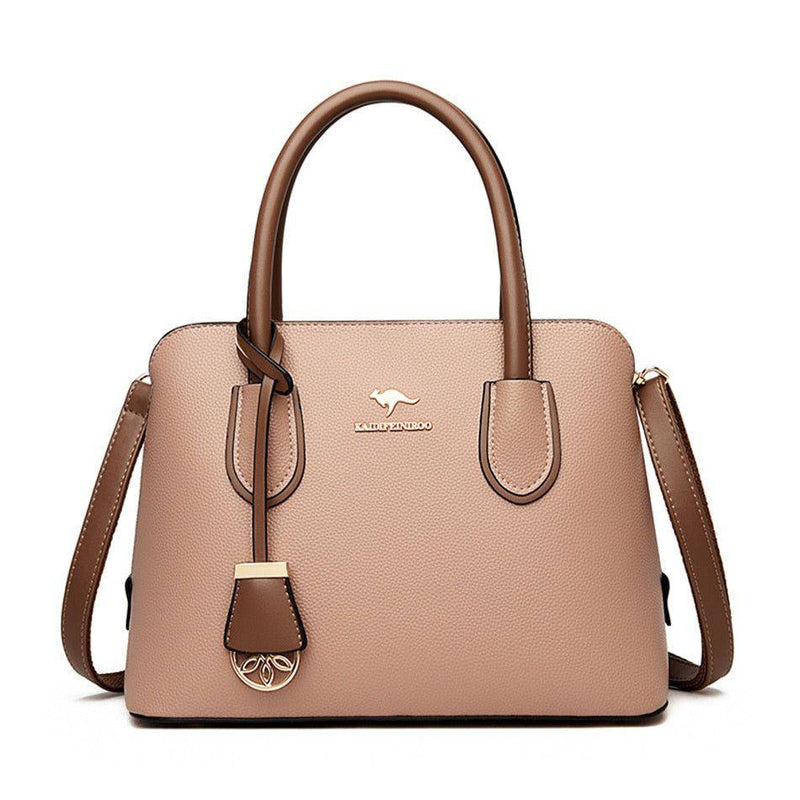 Alt text: Bolsa de couro feminina marrom com alça de mão elegante.