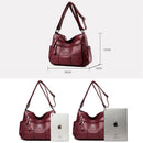 Bolsa tiracolo de couro marrom vinho com alça regulável; dimensões 28x23x13 cm