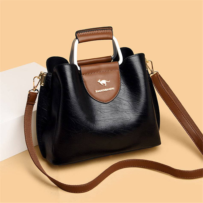 Alt text: Bolsa feminina de couro violet com alça ajustável e elegante.