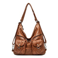 Alt text: Bolsa feminina de couro genuíno Prestige em tom neutro.