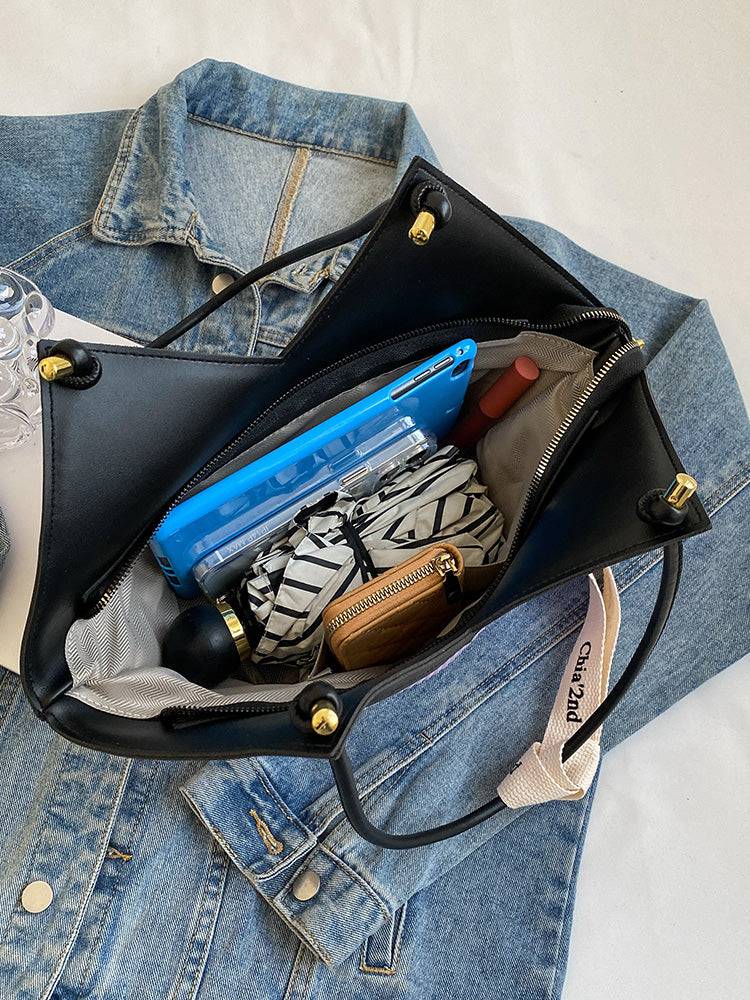 Alt text: Bolsa Tote feminina em couro royale marrom elegante.