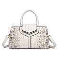 Alt text: Bolsa Satchel Feminina de Couro Elisium em tom neutro.