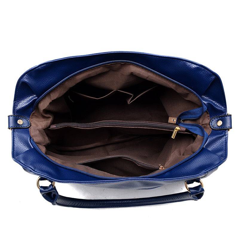 Alt text: Bolsa tiracolo de couro estruturada na cor marrom elegante.