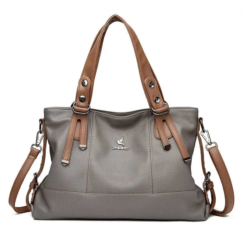 Alt text: Bolsa feminina de mão em couro genuíno marrom elegante.