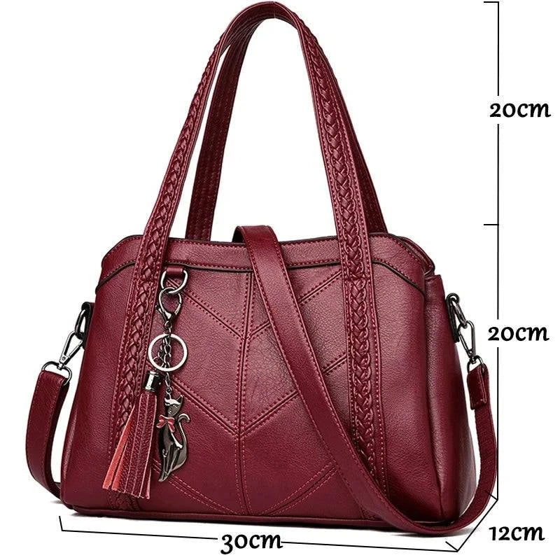 Bolsa tote estruturada preta com alça adicional em couro.
