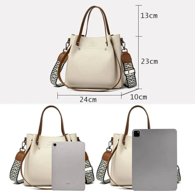 Alt text: Bolsa feminina de couro elegante preta com alça dupla.