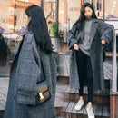Sobretudo longo cinza xadrez oversized com calça preta e tênis branco