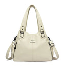 Bolsa feminina de couro sintético off-white com alças duplas, alça transversal e bolsos laterais