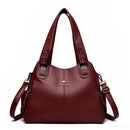 Bolsa feminina de couro vinho com alças duplas e alça transversal