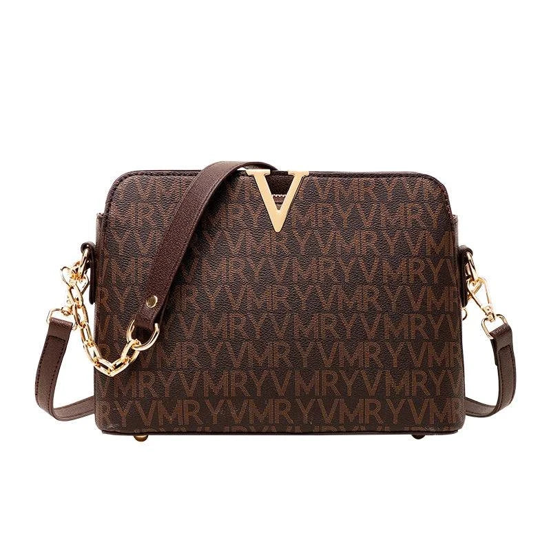 Bolsa Feminina de Couro Elite marrom-escura, estampa monograma, logo "V" dourado. Alça de corrente e transversal. Sofisticada e elegante.