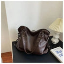 Bolsa feminina de couro marrom com alças duplas e design maleável