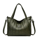 Bolsa feminina de couro verde-oliva com frisos verticais, alças duplas e alça transversal ajustável.