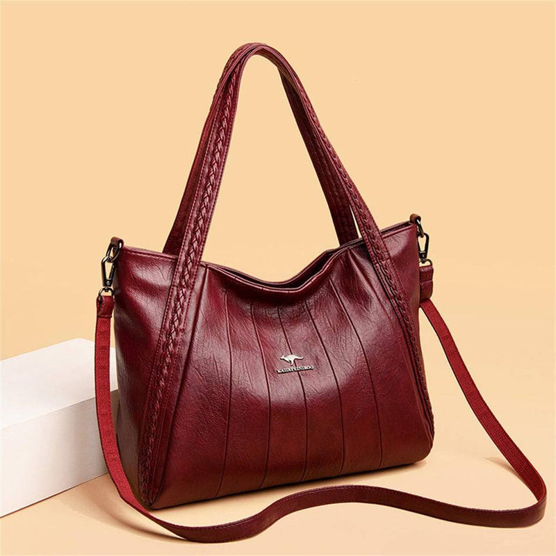 Bolsa Feminina Couro Horizon One vinho, couro macio com frisos frontais e alças trançadas. Alça transversal. Elegante e versátil.
