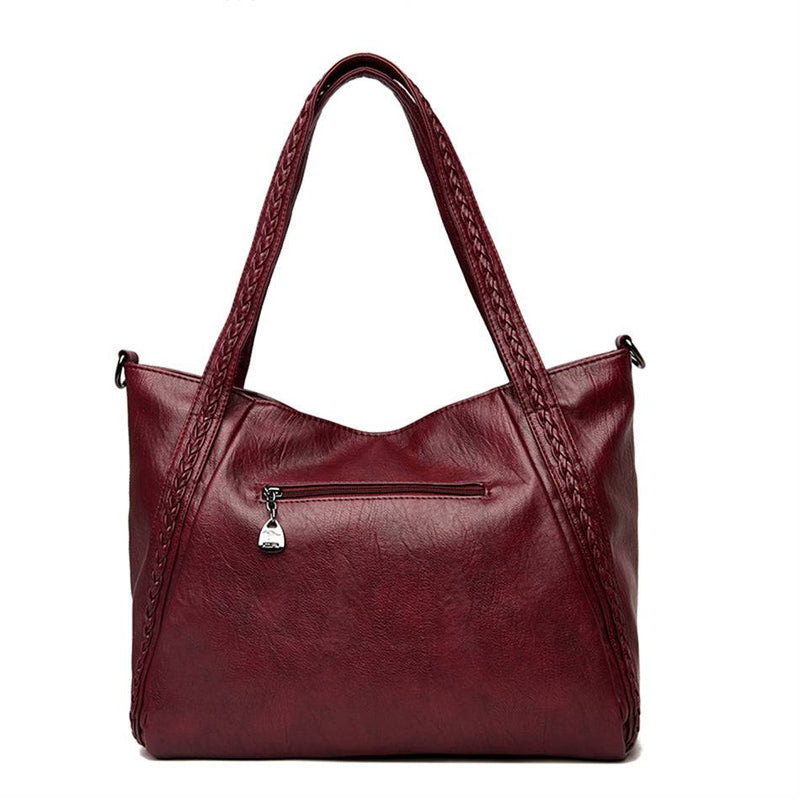 Bolsa Feminina Couro Horizon One vinho. Vista traseira com bolso de zíper e alças trançadas. Prática e espaçosa.