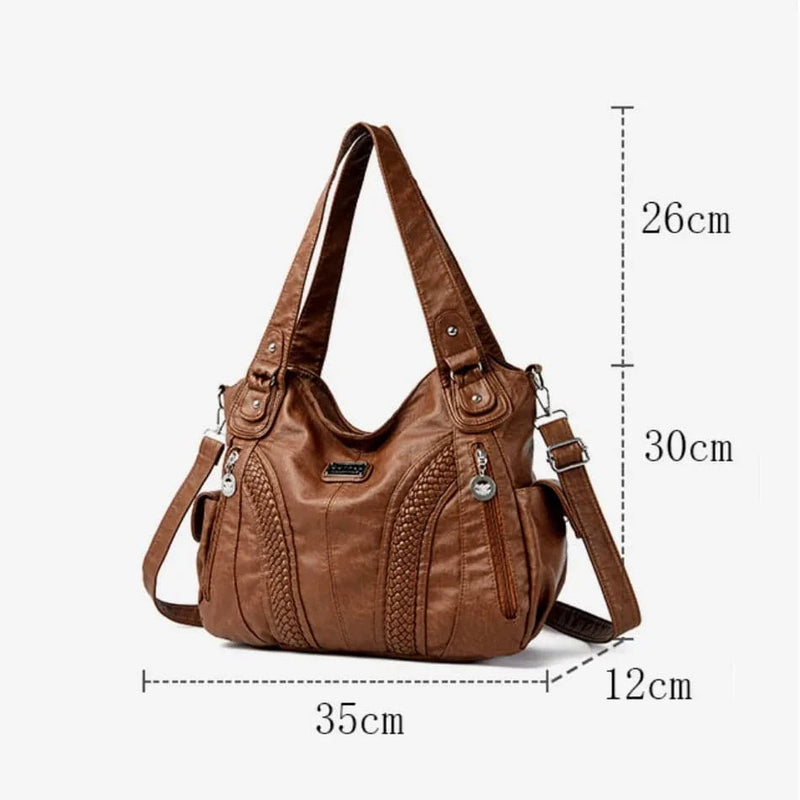 Bolsa feminina de couro legítimo marrom modelo Charmonia, com medidas detalhadas: 35 cm de largura, 30 cm de altura e 12 cm de profundidade, e detalhes prateados nas alças.