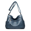 Bolsa feminina de couro azul-acinzentado com bolsos com zíper e alça transversal