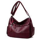 Bolsa de ombro em couro vinho com bolsos com zíper e costura decorativa