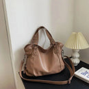 Bolsa tote de couro sintético bege com alças duplas e correia de ombro ajustável