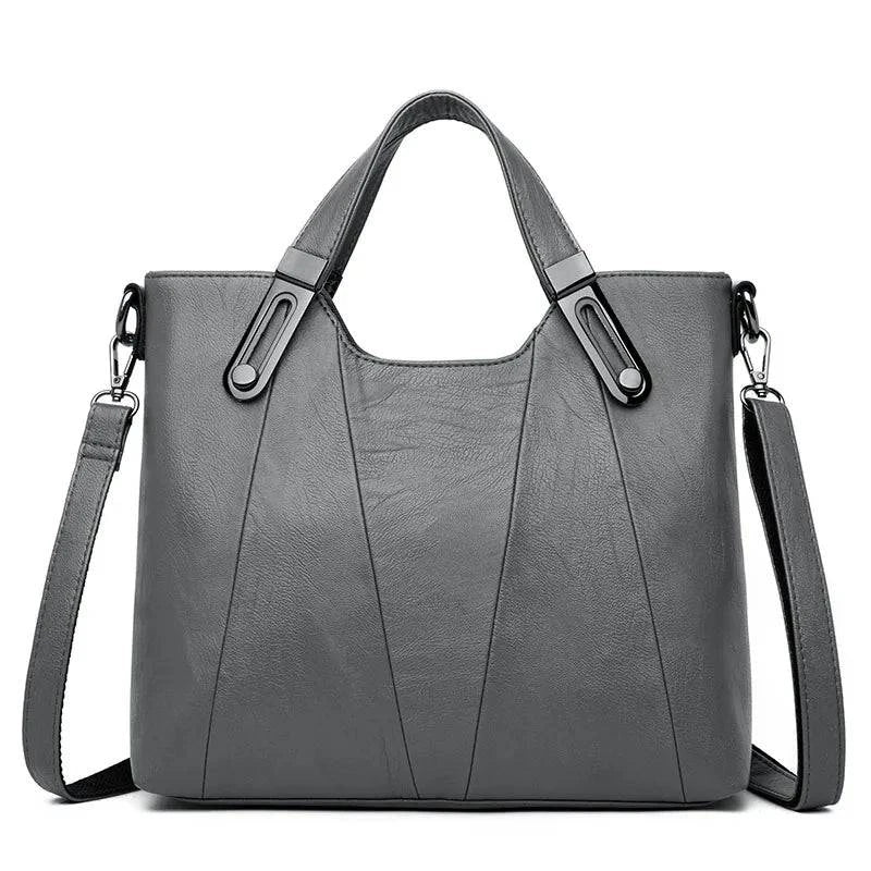 Bolsa Feminina Estruturada Transversal cinza-chumbo, couro sintético texturizado. Alças de mão com ferragens metálicas e alça removível. Elegante e versátil.