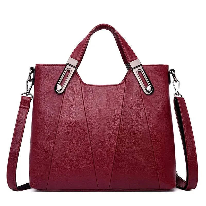 Bolsa Feminina Estruturada Transversal vinho, couro sintético texturizado. Alças de mão com ferragens metálicas e linhas verticais. Elegante e versátil.