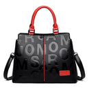 Bolsa feminina preta com estampa de letras em relevo, alças vermelhas e zíper vermelho frontal