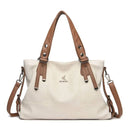 Bolsa de couro bege com alças e corrente destacáveis em marrom