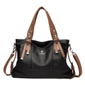 Bolsa Feminina de Mão Couro Genuíno preta e marrom, com detalhes de alças contrastantes. Design estruturado e ferragens metálicas. Elegante e versátil.