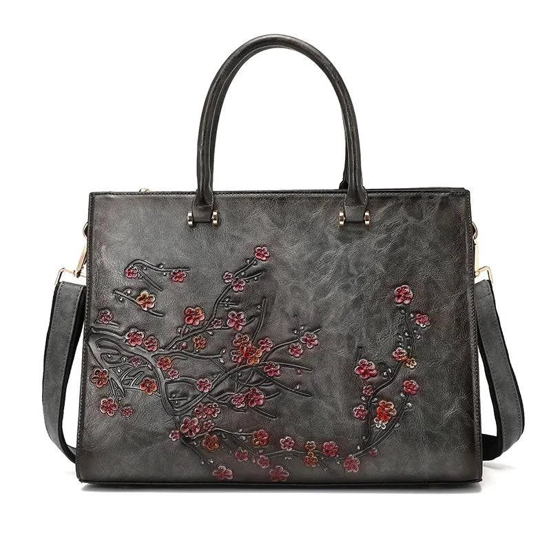 Bolsa Feminina Tote Couro Legítimo Imperix cinza-chumbo, com relevo floral em tons de rosa e marrom. Design estruturado, alças de mão e transversal. Estilo vintage e único.