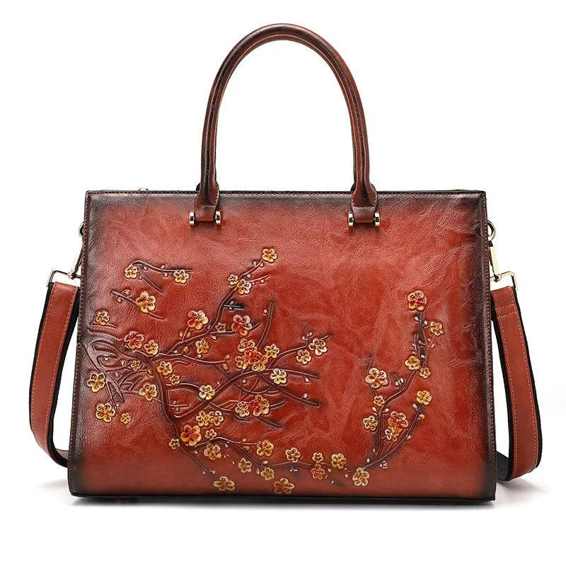 Bolsa Feminina Tote Couro Legítimo Imperix marrom, com relevo floral colorido. Design estruturado, alças de mão e transversal. Estilo vintage e único.