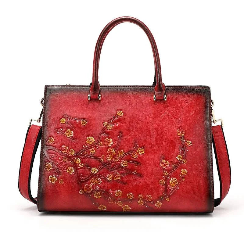 Bolsa Feminina Tote Couro Legítimo Imperix vermelha, com relevo floral em tons de amarelo e laranja. Design estruturado, alças de mão e transversal. Estilo vintage e único