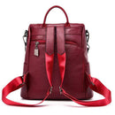 Mochila de couro vinho com alças vermelhas acolchoadas, vista traseira