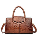 Bolsa satchel marrom com textura de couro crocodilo e alças duplas estruturadas