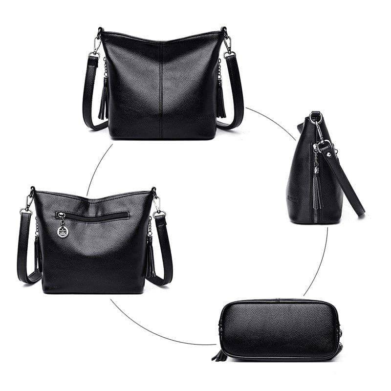 Bolsa tiracolo de couro feminina Ladies preta com textura granulada, exibida em vistas frontal, traseira com zíper, lateral e inferior, destacando seu design compacto e alça com corrente.