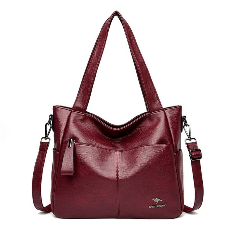 Bolsa tote de couro feminina Lara vinho com alças de ombro e alça transversal, múltiplos bolsos frontais com zíper e logotipo de canguru, design espaçoso e versátil.