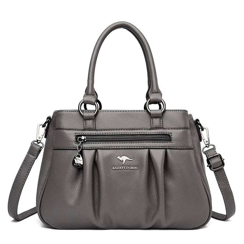 Bolsa Tote Estruturada Feminina Couro Radiance cinza. Zíper frontal, pregas, ferragens prateadas. Elegante e funcional para o dia a dia.