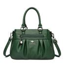 Bolsa tote estruturada verde em couro com zíper frontal, alças e correia transversal ajustável