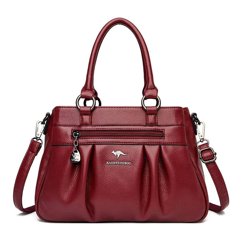 Bolsa Tote Estruturada Feminina Couro Radiance vinho. Zíper frontal, pregas, ferragens prateadas. Elegante e funcional para o dia a dia.