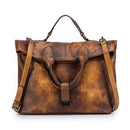 Bolsa tote de couro marrom com acabamento vintage, alças duplas e detalhe costurado frontal