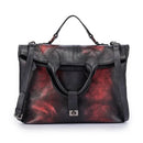Bolsa tote feminina de couro preto e vinho com detalhes metálicos e efeito vintage