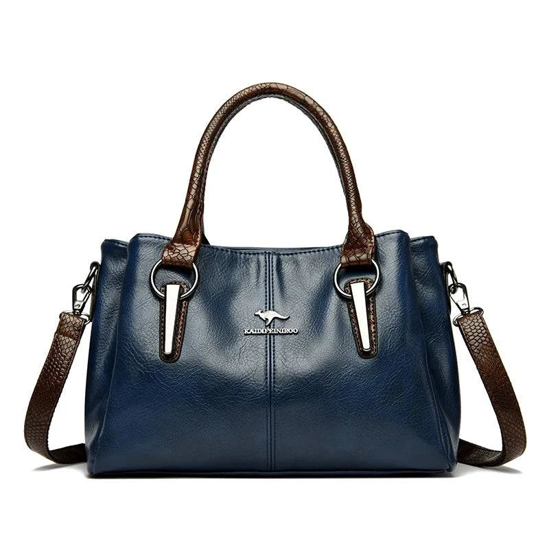 Bolsa Tote Feminina Couro Sublime azul-marinho. Alças duplas e transversal marrom com textura, ferragens metálicas e logo. Elegante e versátil.