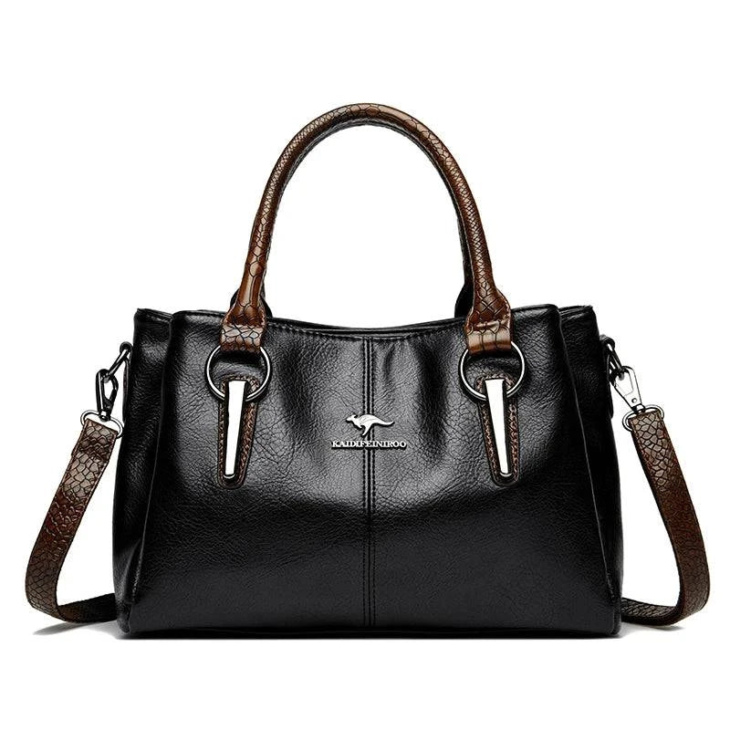 Bolsa Tote Feminina Couro Sublime preta. Alças duplas e transversal marrom com textura, ferragens metálicas e logo. Elegante e versátil.