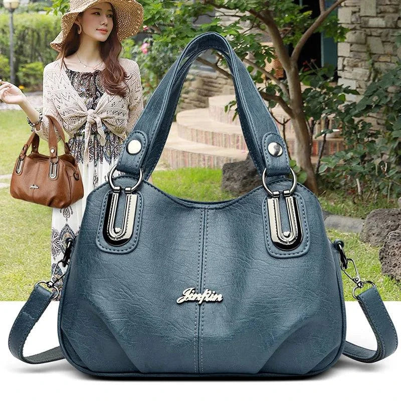 Bolsa Tote Feminina Estruturada Pequena azul, couro macio, ferragens prateadas. Prática e charmosa para o dia a dia.