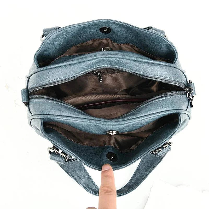 Bolsa Tote Feminina Estruturada Pequena azul, interior com múltiplos compartimentos e zíperes. Espaçosa e funcional.