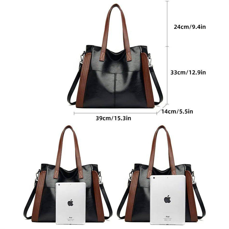 Bolsa tote feminina de couro sintético Sofia preta com detalhes marrons, exibindo dimensões de 39x33x14cm e comparativo de tamanho com um iPad, ideal para trabalho ou estudo.