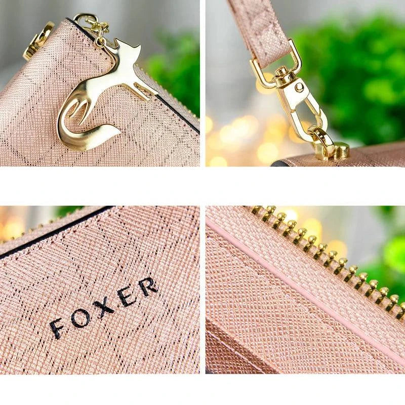Detalhes da carteira feminina de couro Mônaco rosa claro: close-ups do charm de gato dourado, encaixe da alça de pulso, logotipo "FOXER" e zíper dourado, exibindo a textura quadriculada.